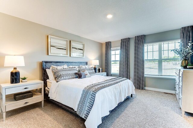 bedroom with carpet and a textured ceiling