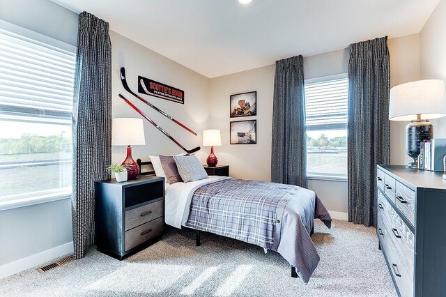 bedroom featuring light carpet