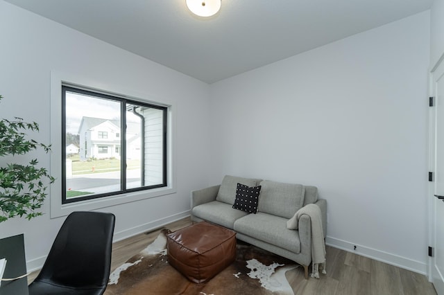 home office featuring wood finished floors and baseboards