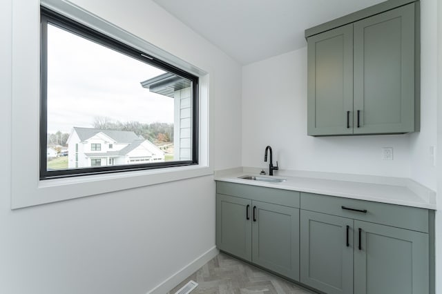 interior space featuring visible vents, a sink, and baseboards