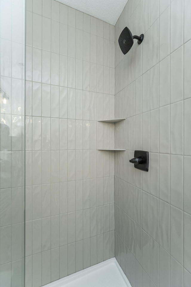 full bathroom with a tile shower