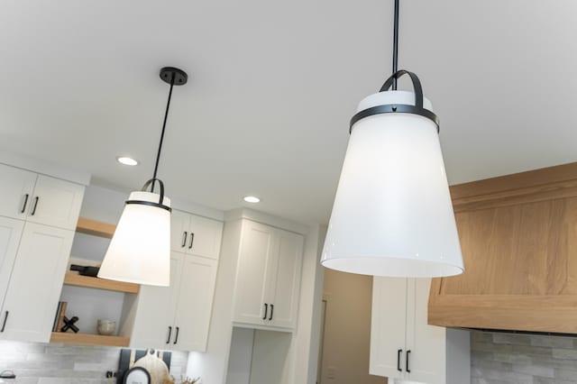 interior details featuring open shelves, hanging light fixtures, decorative backsplash, and white cabinets