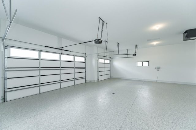 garage with baseboards and a garage door opener