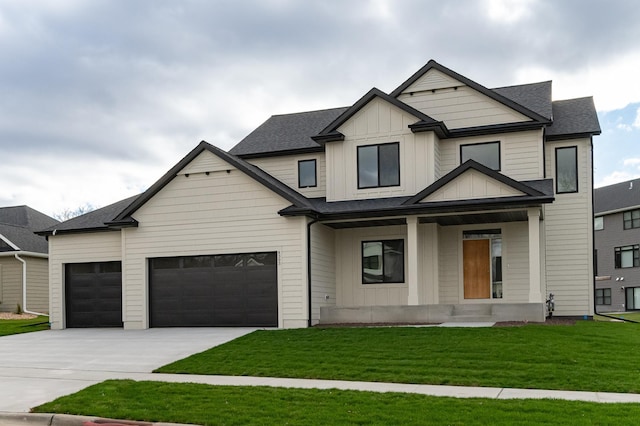 view of front of home featuring a porch, board and batten siding, a front yard, a garage, and driveway