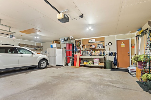 garage featuring white fridge, a garage door opener, and a workshop area