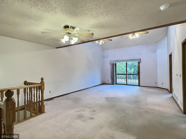 carpeted spare room featuring ceiling fan and a textured ceiling