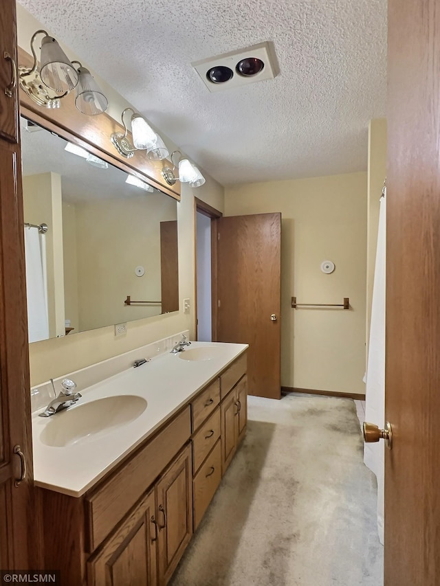 bathroom featuring vanity and a textured ceiling