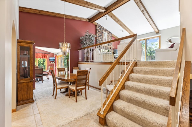 dining area featuring high vaulted ceiling, an inviting chandelier, and beamed ceiling