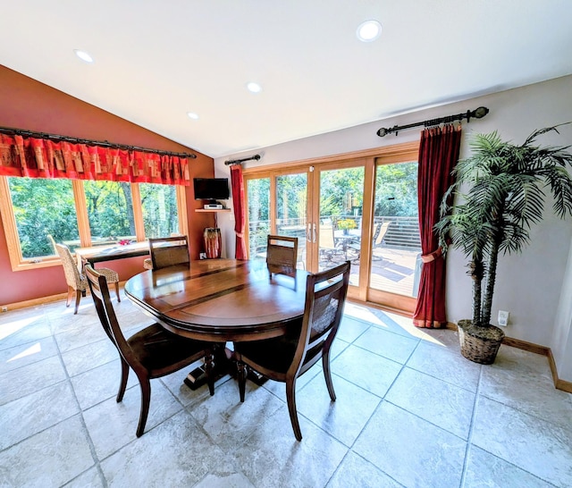 dining room with french doors and vaulted ceiling