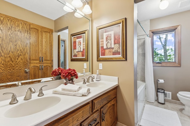 full bathroom with shower / bath combo, tile patterned floors, vanity, and toilet