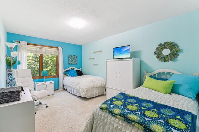 bedroom featuring carpet flooring and a textured ceiling