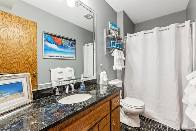 bathroom featuring vanity, toilet, and curtained shower