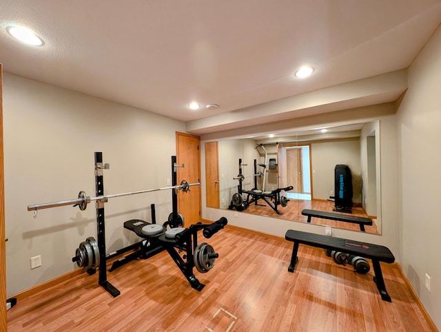 exercise room with light hardwood / wood-style floors