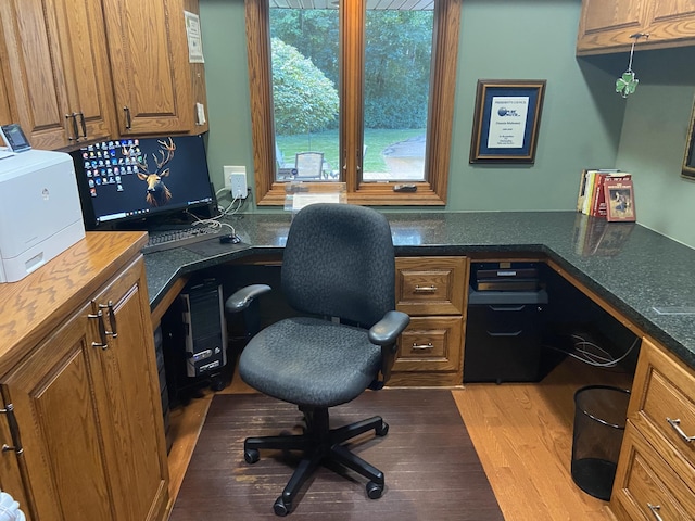 office space featuring built in desk and light hardwood / wood-style floors