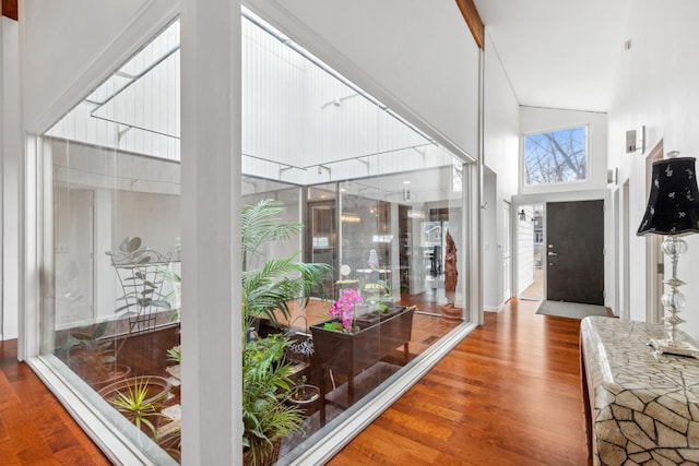 interior space featuring hardwood / wood-style floors and high vaulted ceiling