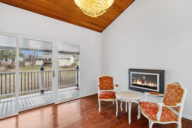 living area featuring a notable chandelier, wood ceiling, vaulted ceiling, and hardwood / wood-style flooring