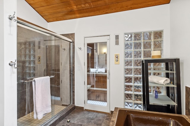 bathroom with tile patterned flooring, walk in shower, lofted ceiling, and wood ceiling