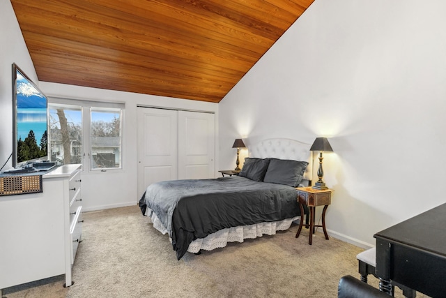 bedroom with lofted ceiling, light carpet, wood ceiling, and a closet