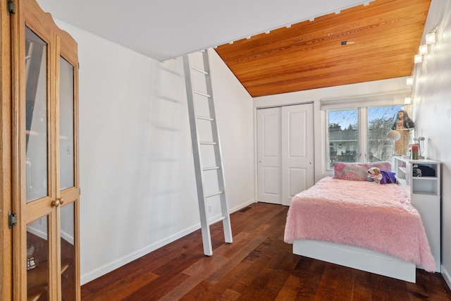 bedroom with wooden ceiling, a closet, dark wood-type flooring, and lofted ceiling