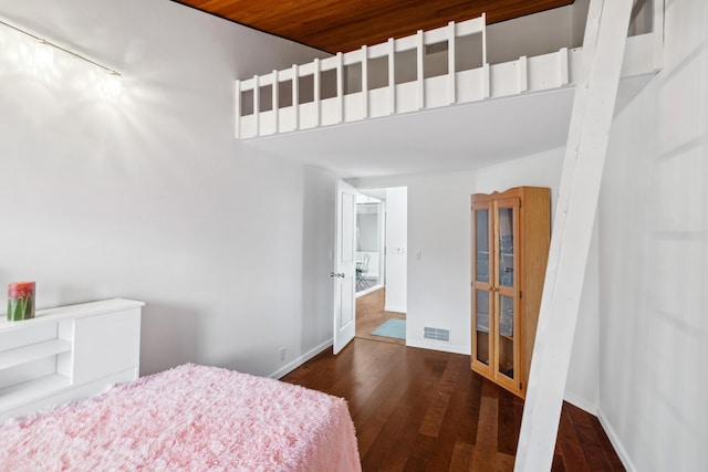 bedroom with dark hardwood / wood-style flooring and wooden ceiling