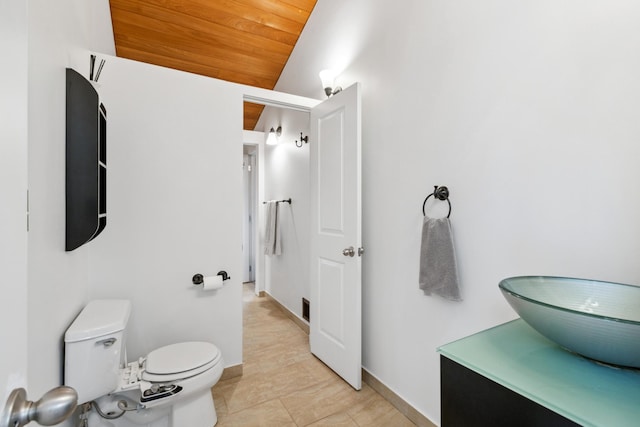 bathroom with vanity, vaulted ceiling, wooden ceiling, tile patterned flooring, and toilet