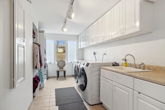 laundry room featuring cabinets, track lighting, sink, independent washer and dryer, and light tile patterned flooring