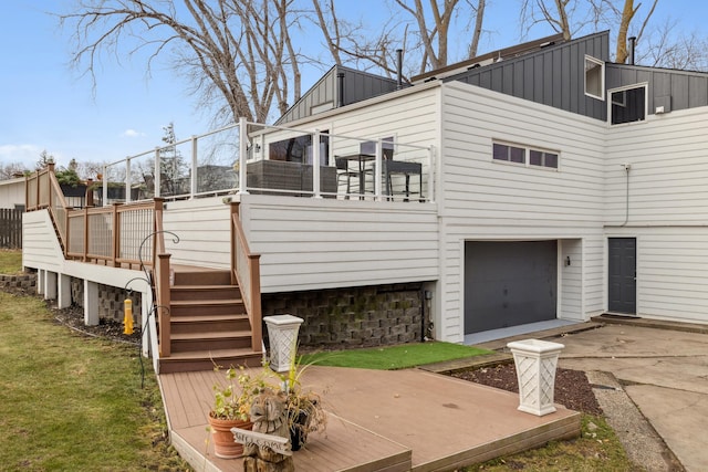 view of side of property featuring a garage and a wooden deck