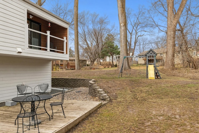 view of yard featuring a playground and a deck