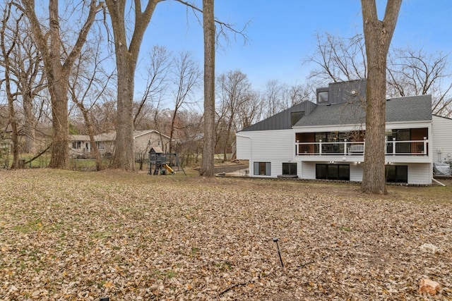 view of yard with a playground and a sunroom