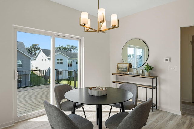 dining room featuring a chandelier and light hardwood / wood-style floors