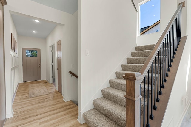 stairs featuring hardwood / wood-style floors