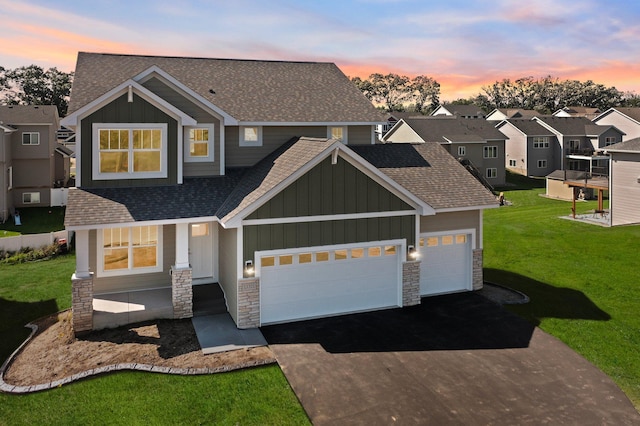 craftsman house featuring a yard and a garage