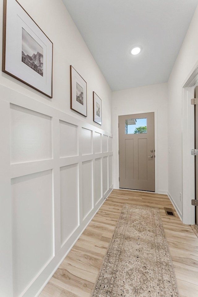 doorway with light wood-type flooring