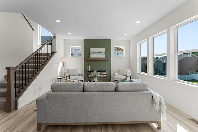 living room with a fireplace and light hardwood / wood-style flooring