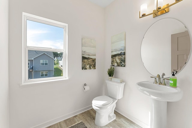 bathroom with wood-type flooring and toilet