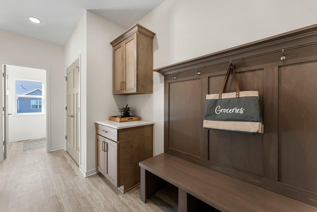 mudroom with light hardwood / wood-style flooring