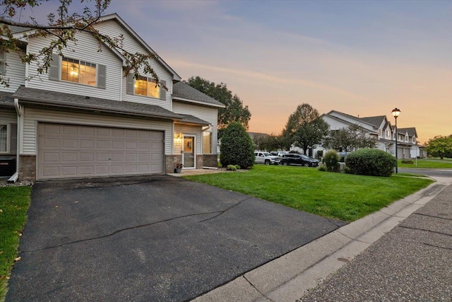 view of front of property with a front yard, a garage, and driveway