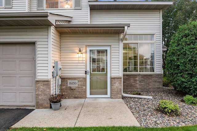 view of exterior entry with an attached garage