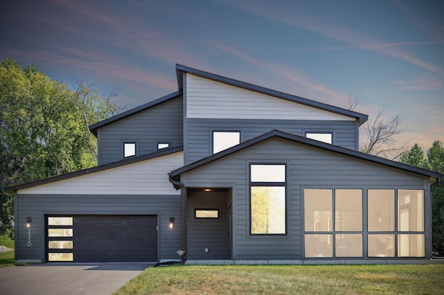 contemporary home with a yard and a garage