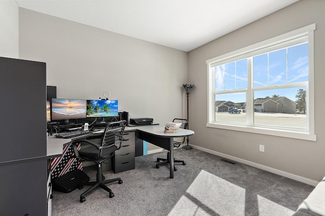 office area featuring carpet flooring, baseboards, and visible vents