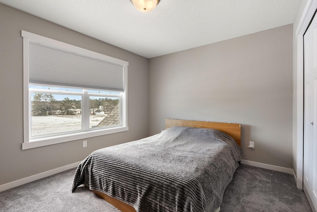 carpeted bedroom with baseboards