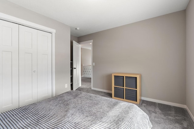 unfurnished bedroom with a closet, carpet flooring, and baseboards