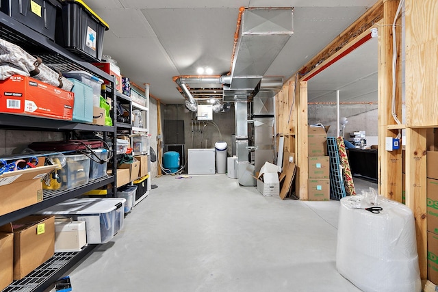 unfinished basement featuring heating unit