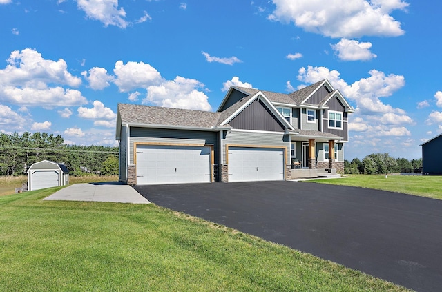 craftsman house featuring aphalt driveway, board and batten siding, an attached garage, and a front yard