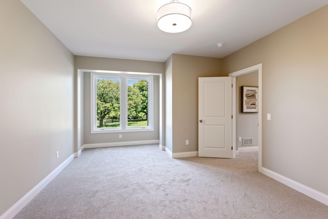 unfurnished bedroom featuring light colored carpet