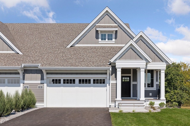 view of front facade with a garage and a porch