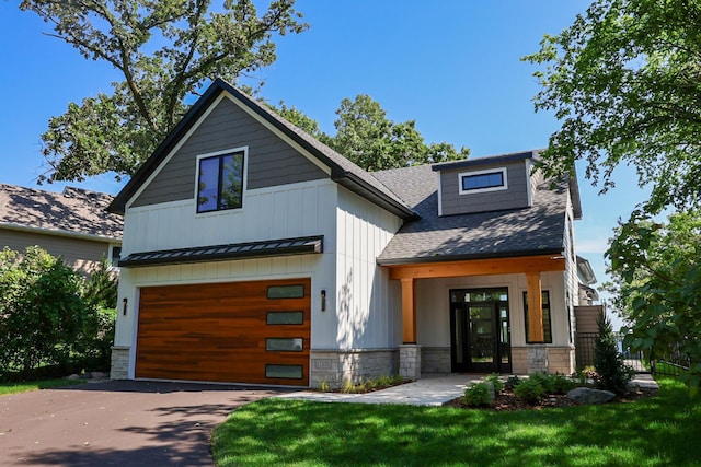 view of front of house featuring a garage and a front lawn