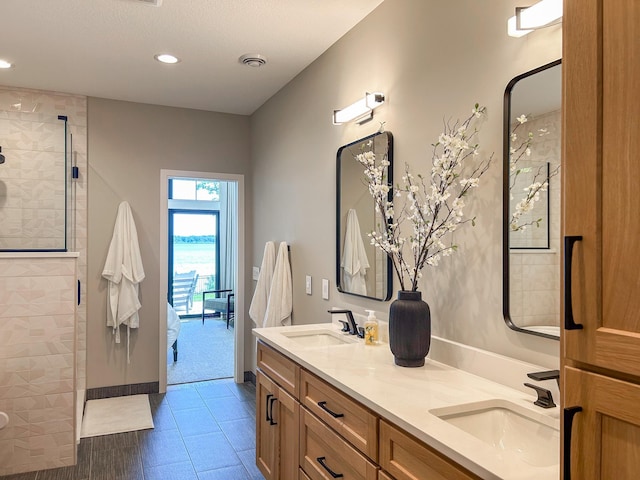 bathroom featuring vanity and a tile shower