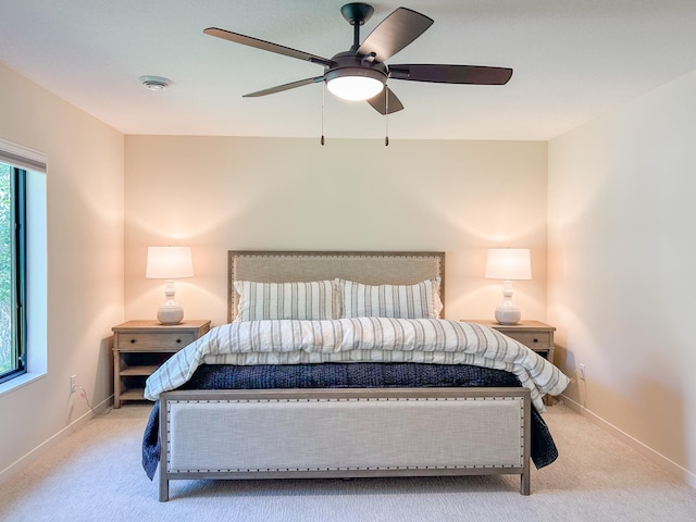 bedroom featuring ceiling fan and light colored carpet