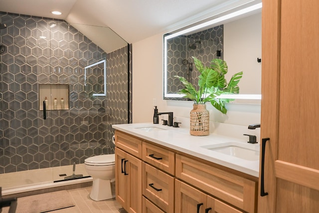 bathroom with a shower with door, tile patterned floors, vaulted ceiling, toilet, and vanity